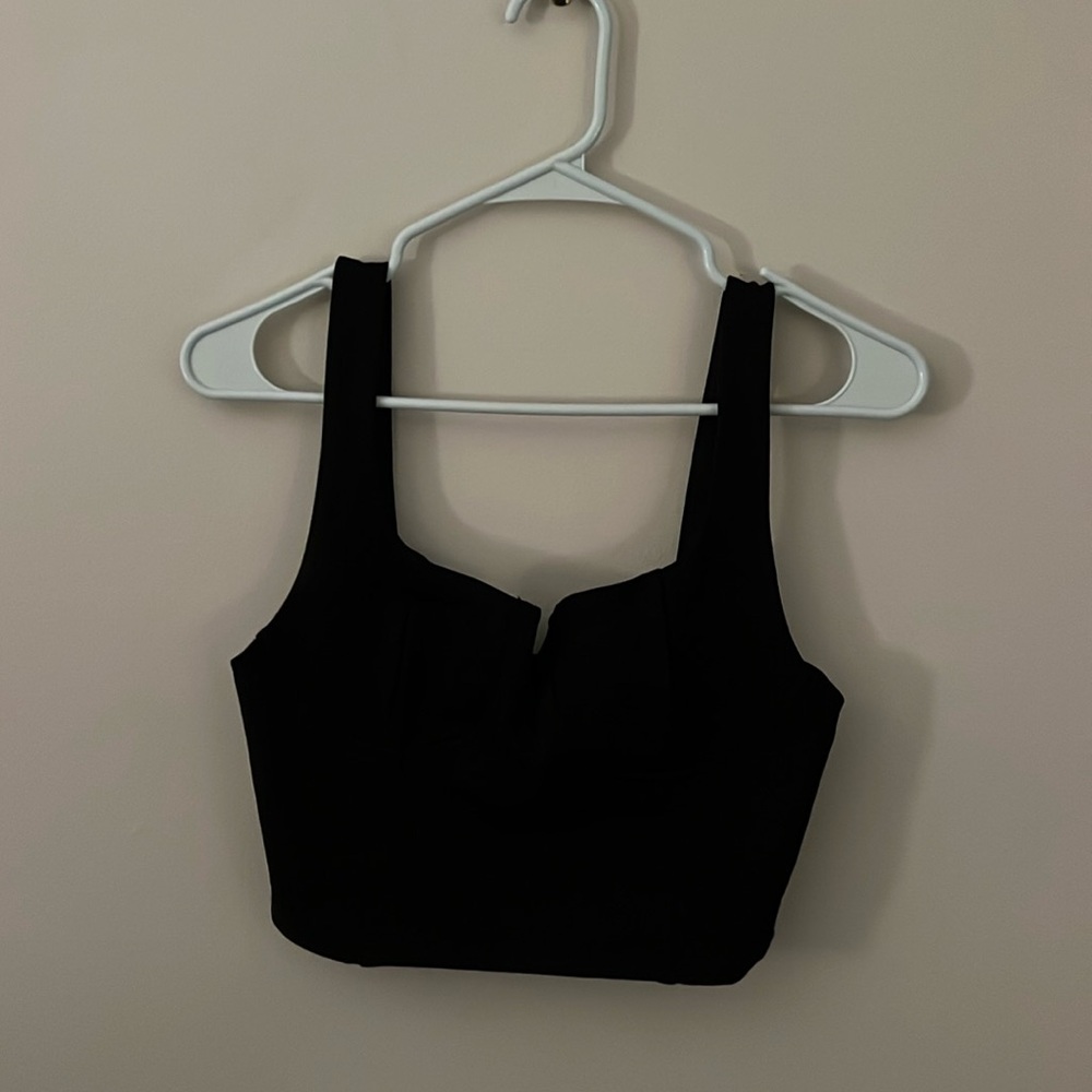 black crop top with cup details and a metal v insert
